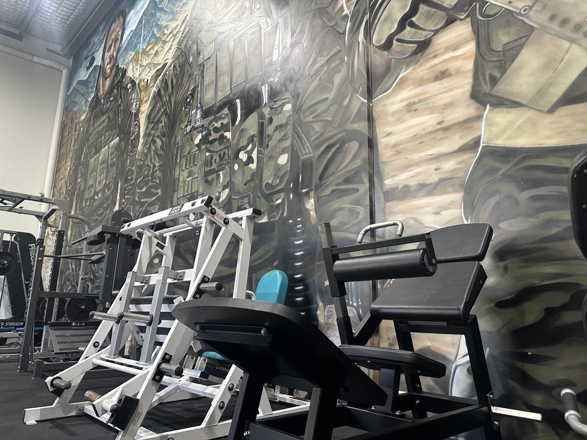 Strength equipment in front of the soldier mural